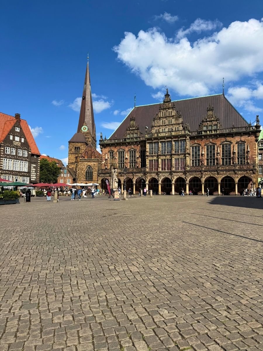 Bremen’s UNESCO-listed Town Hall stands proudly next to the tall spire of St. Martin’s Church, overlooking the historic cobblestone square.