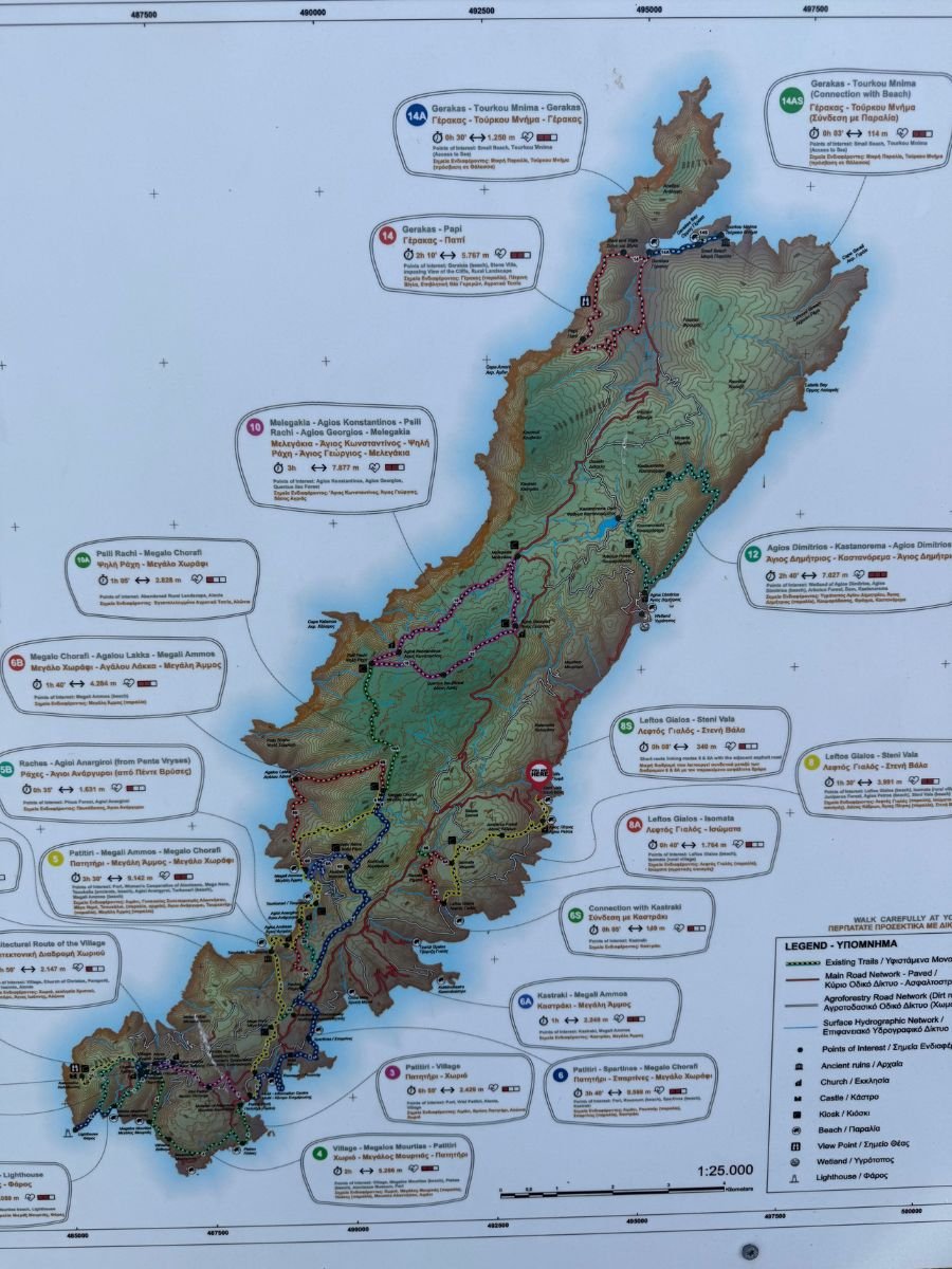 Detailed topographic hiking trail map of Alonissos island, Greece, showing numbered walking routes with elevation markers, trail distances, and points of interest including beaches, churches, and villages.