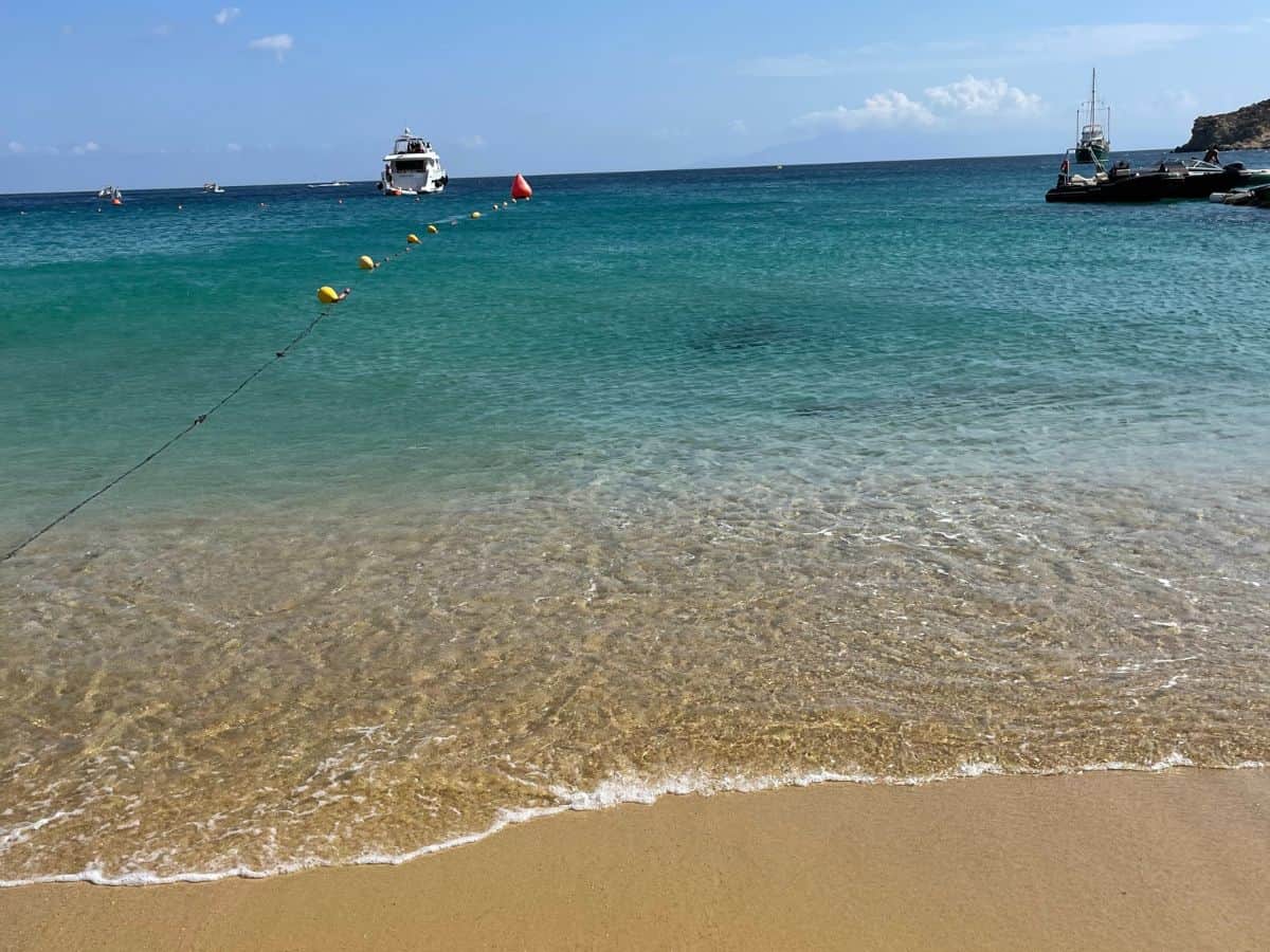 The beach in Mykonos with Crystal blue waters and golden sand