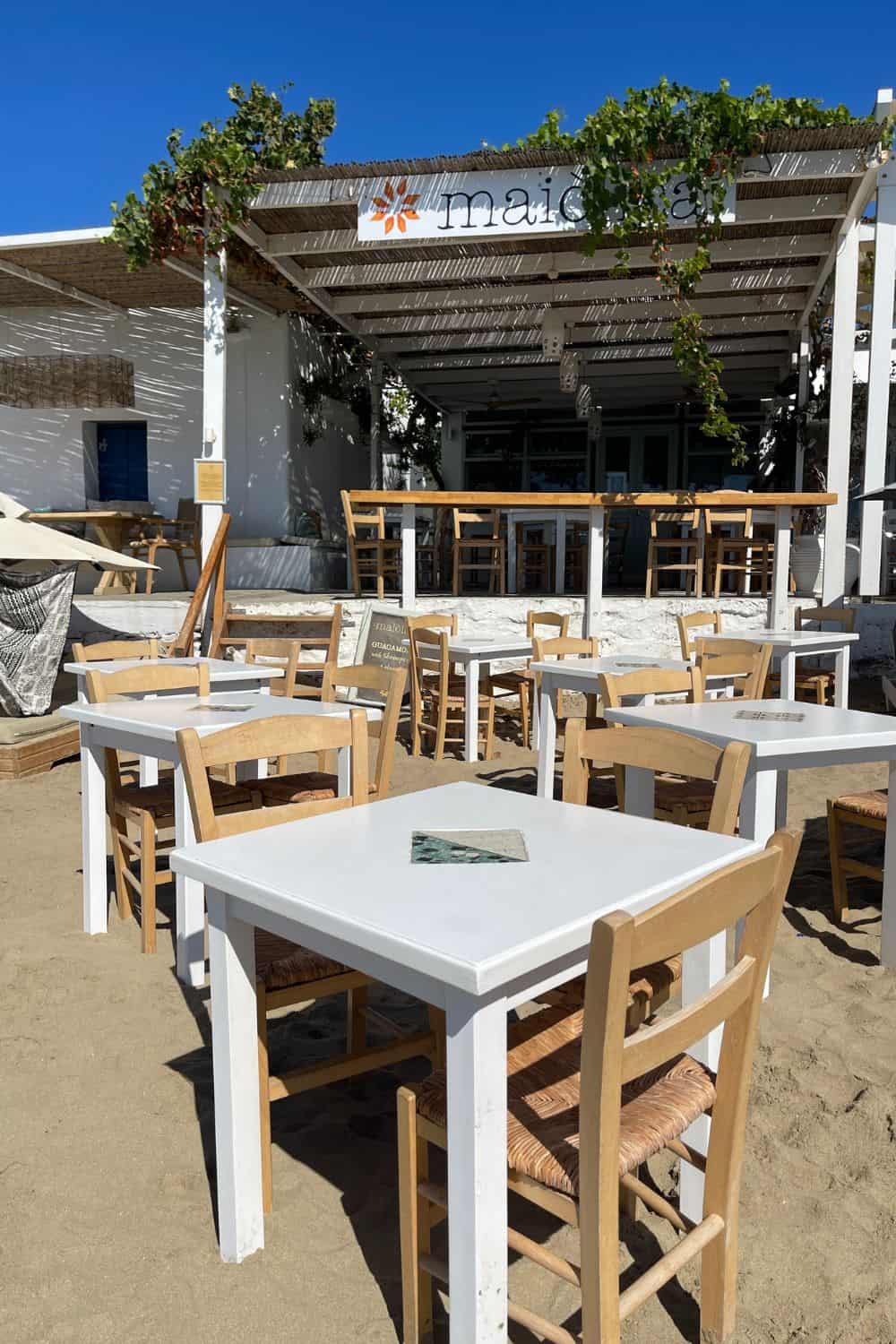 Outdoor dining tables on the sand. 