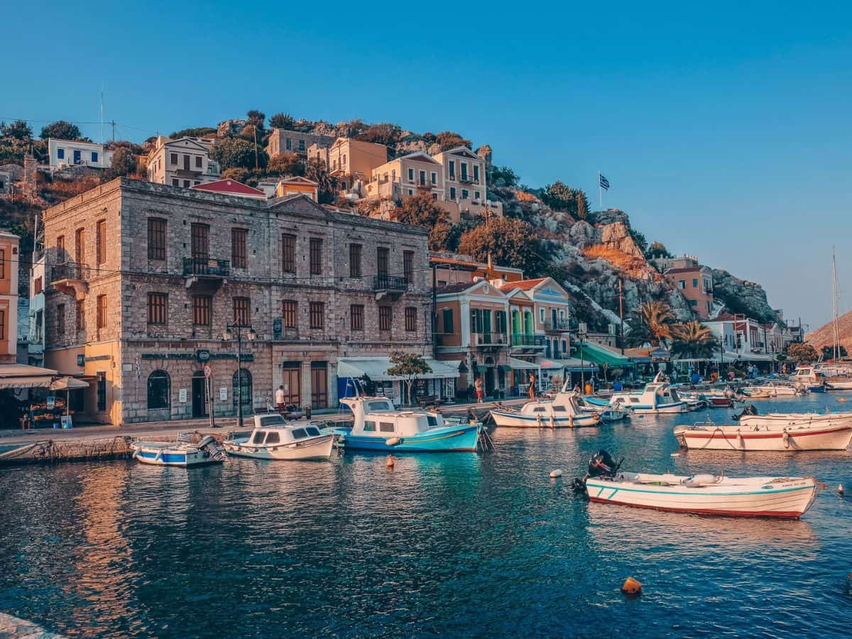 An idyllic greek island setting of the colorful boats in the water.