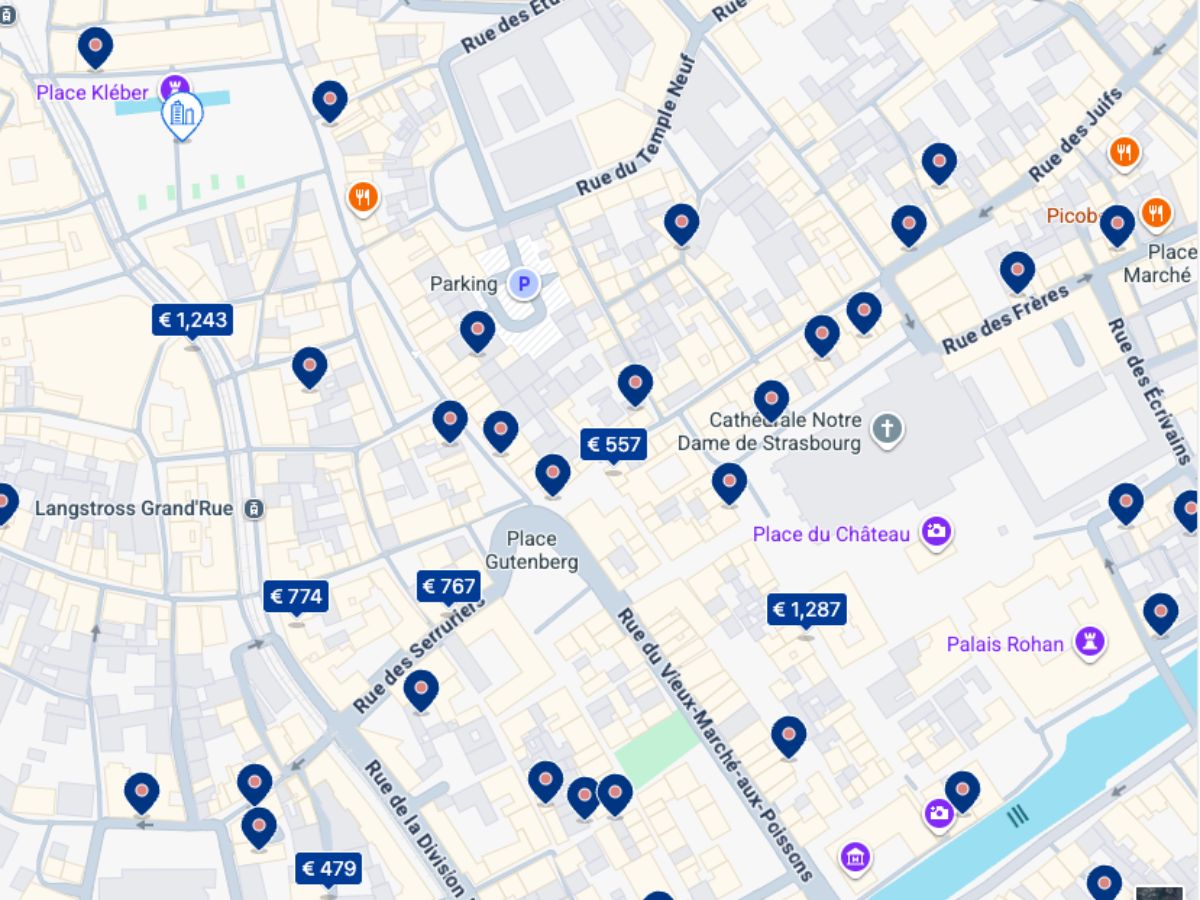 Map view of Strasbourg city center hotel availability for the Christmas Market as of September 23. Most properties near Place Gutenberg and the Strasbourg Cathedral are marked with blue pins showing prices, with many already sold out.