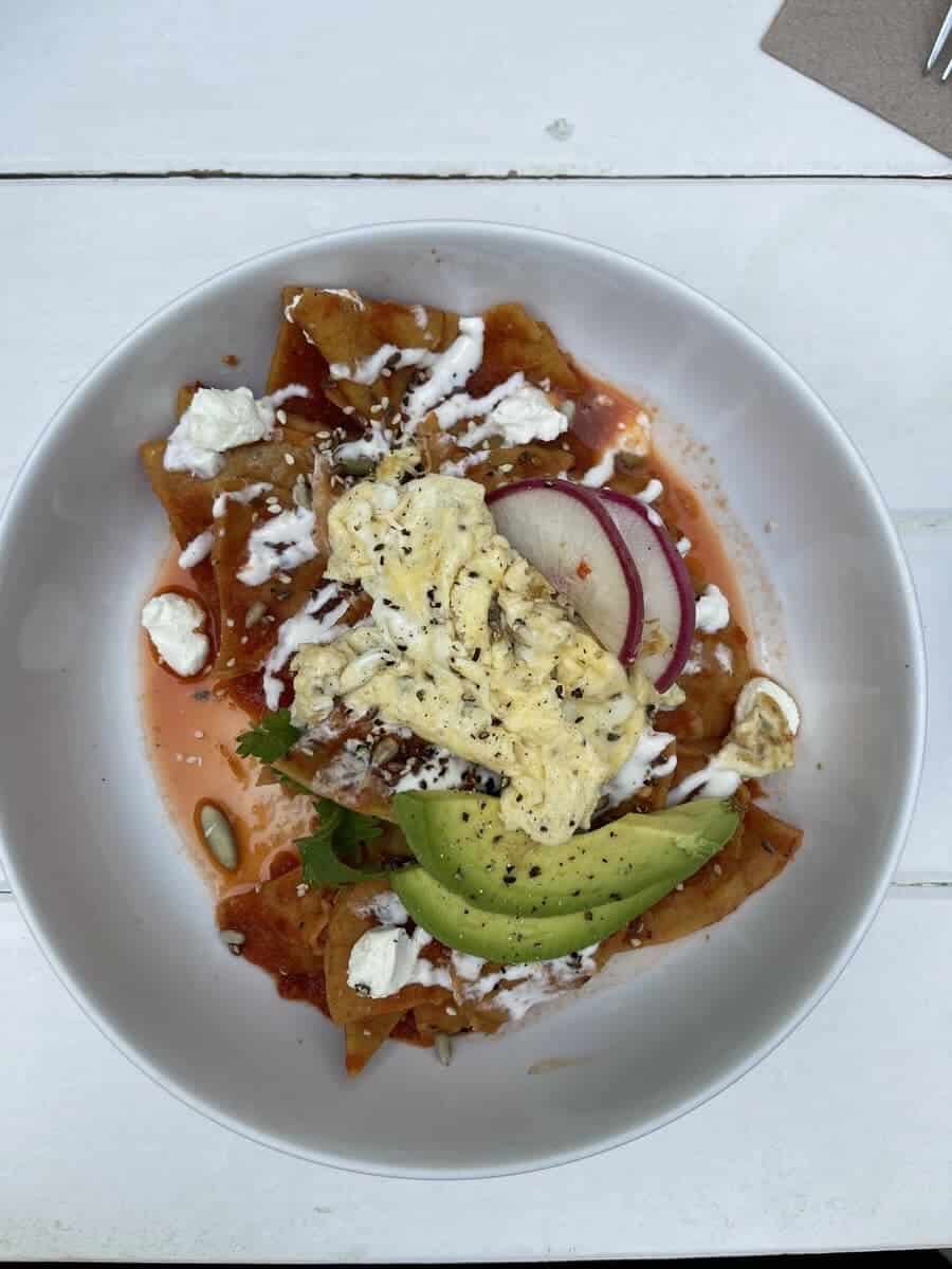 scrambled eggs on plate with avocado