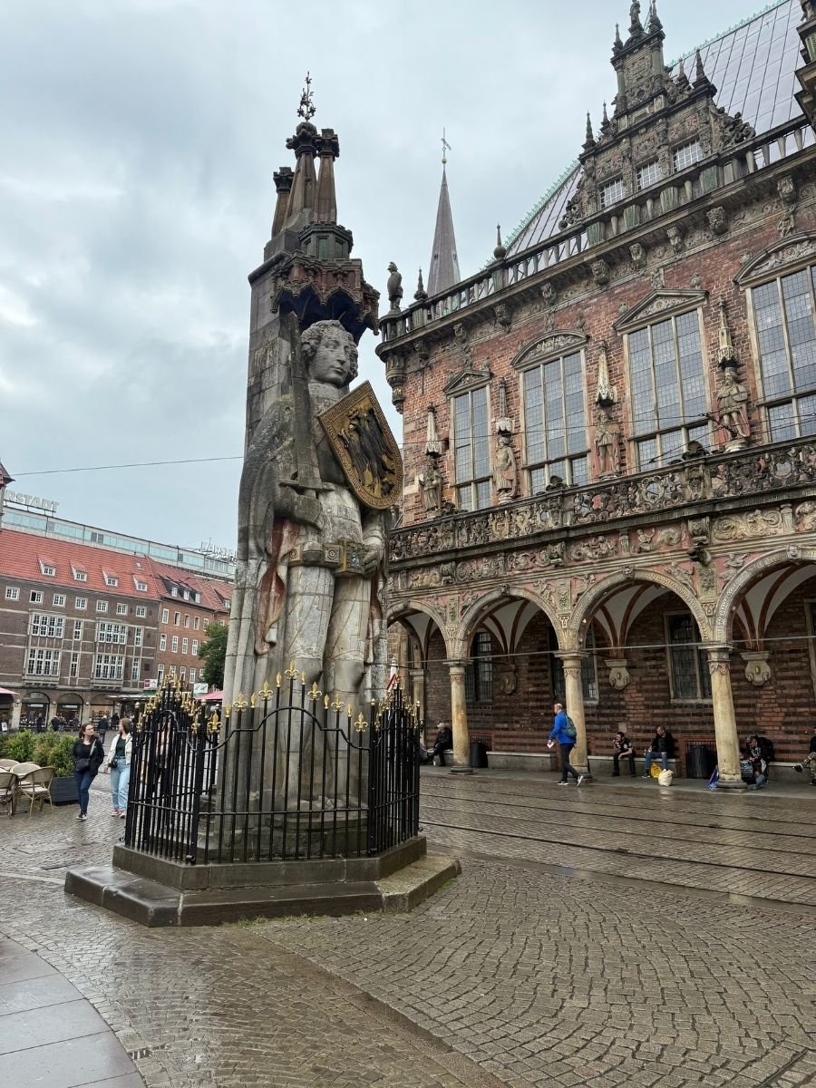Statue of Roland standing before the ornate facade of the Town Hall in Bremen, Germany.