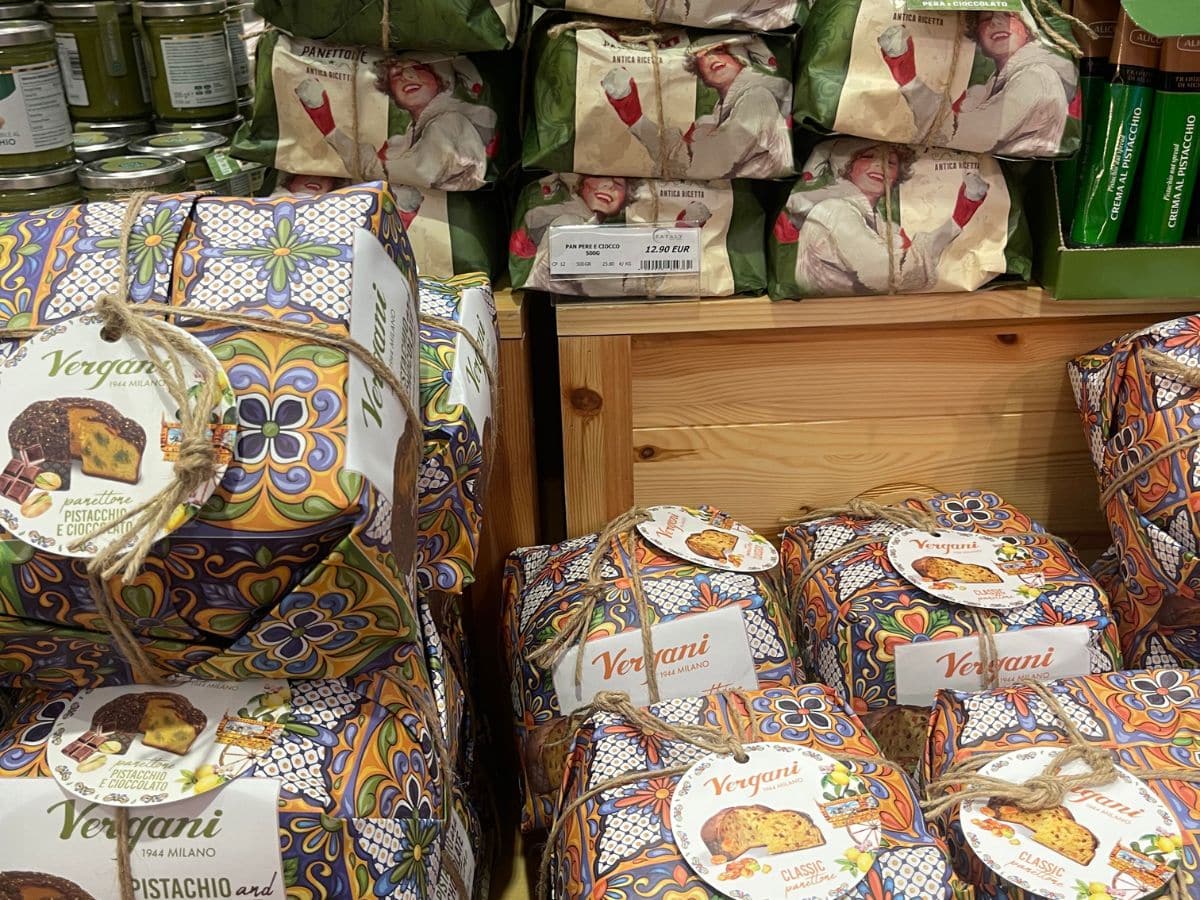 Festive scene featuring Christmas decorations with warm lights, ornaments, and holiday-themed decor in Bologna, Italy. The setting captures the cozy, inviting atmosphere of a Christmas market with decorative elements that highlight traditional holiday charm.