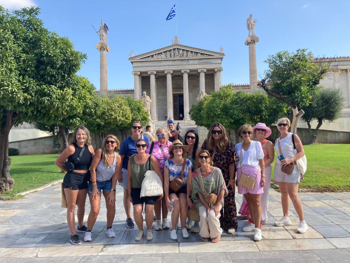 A group of women in front of the Athens museum.