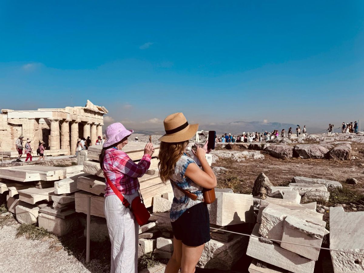 Two women taking pictures at the Acropolis