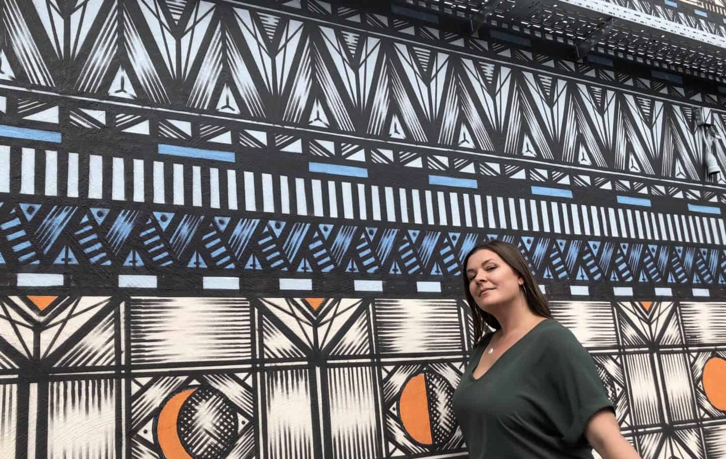 Posing in front of a mural in Berlin, Germany.