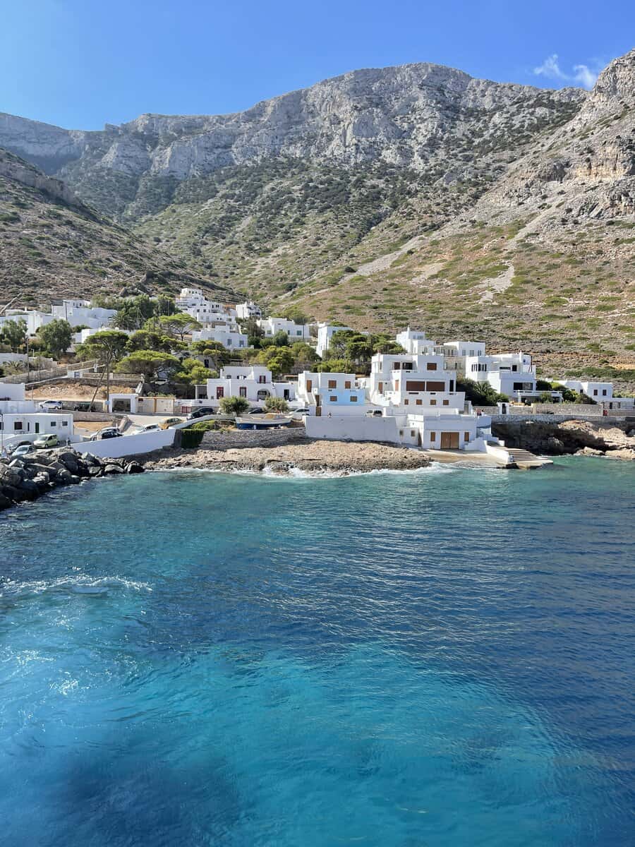 The blue ocean with beach and white houses and mountainous background