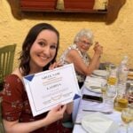 a girl holding her certificate in Greece.