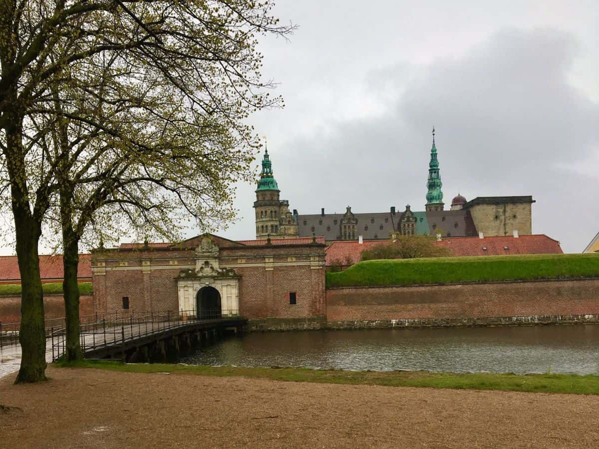 View of the castle courtyard surrounded by ancient stone walls and greenery.