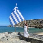 A woman holding the Greek flag.