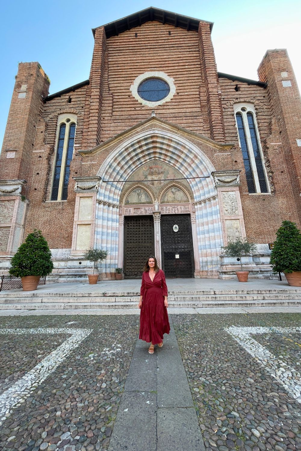 A woman standing in front of the Church in Verona