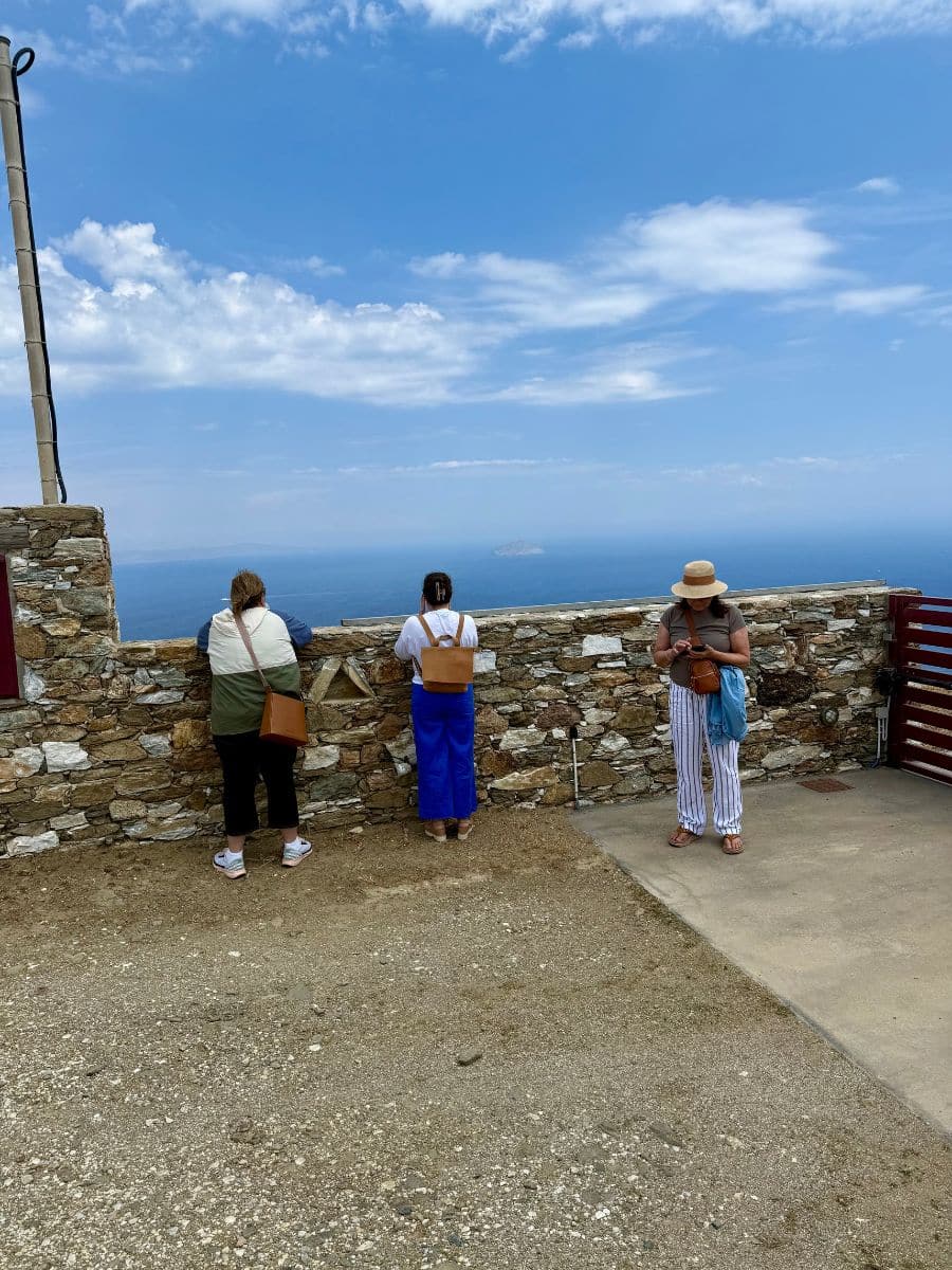 Group of women admiring panoramic sea views from a hilltop on a Greek island trip
