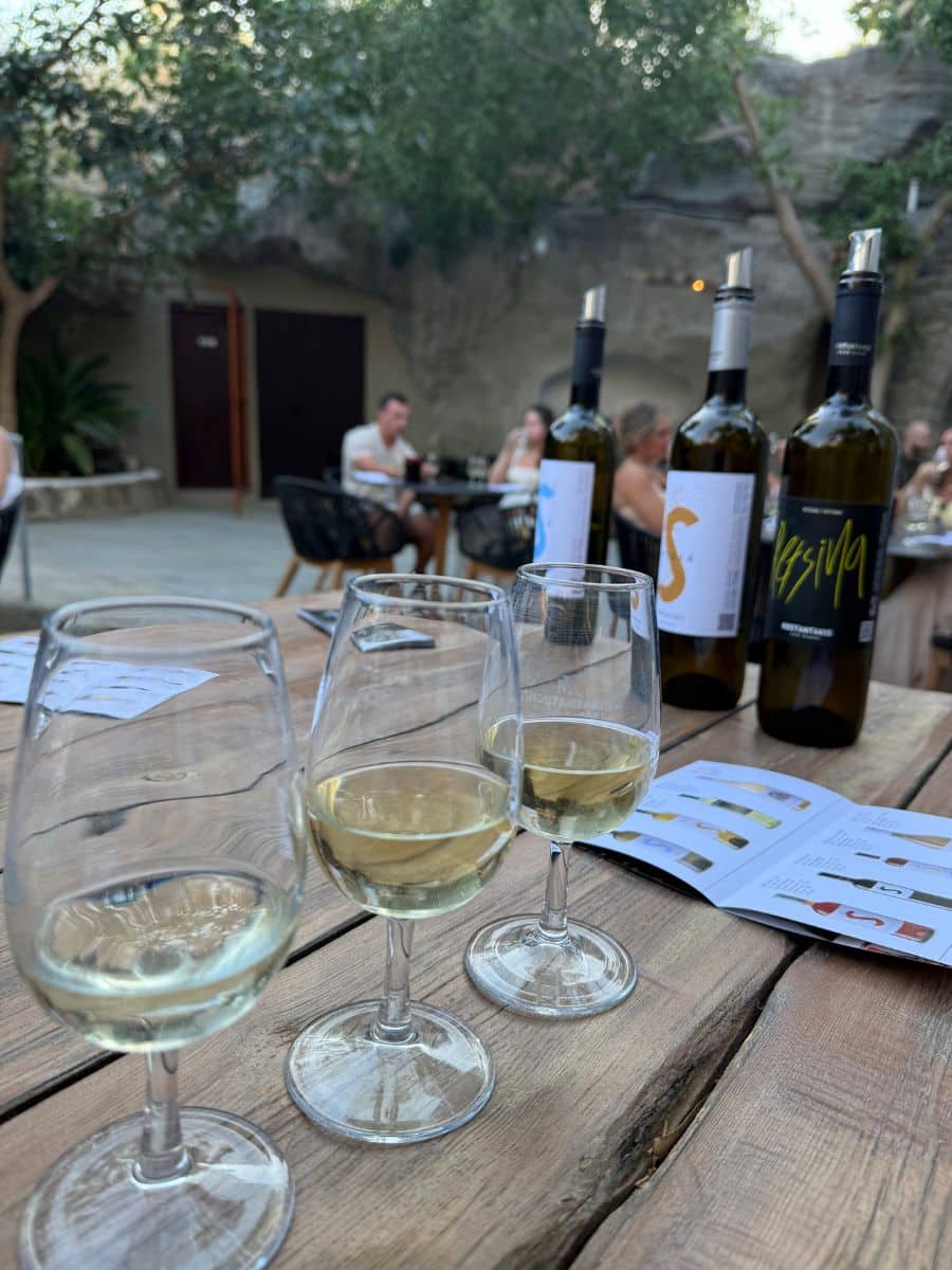 Wine glasses filled with white wine during a tasting on a Greek islands women-only trip