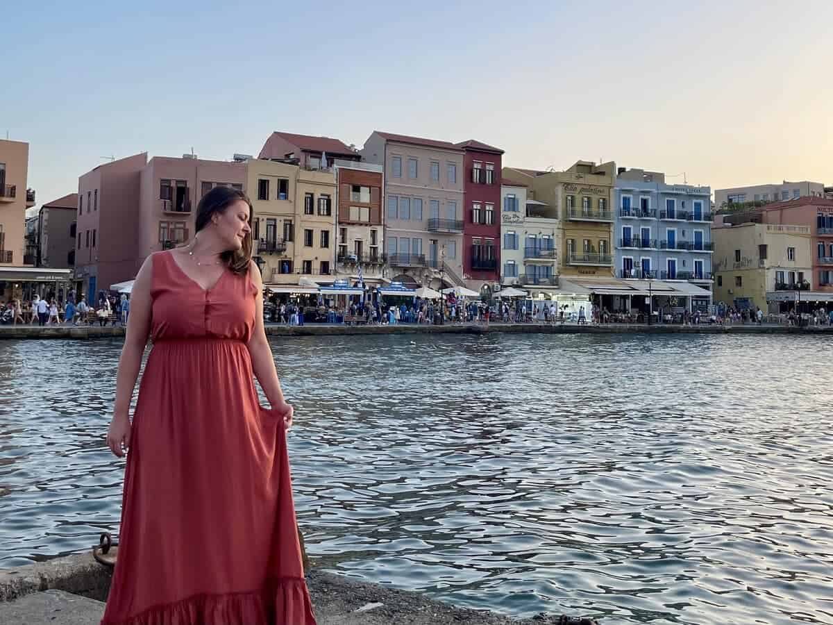 A woman standing alone in Chania, Crete at the Harbor. 