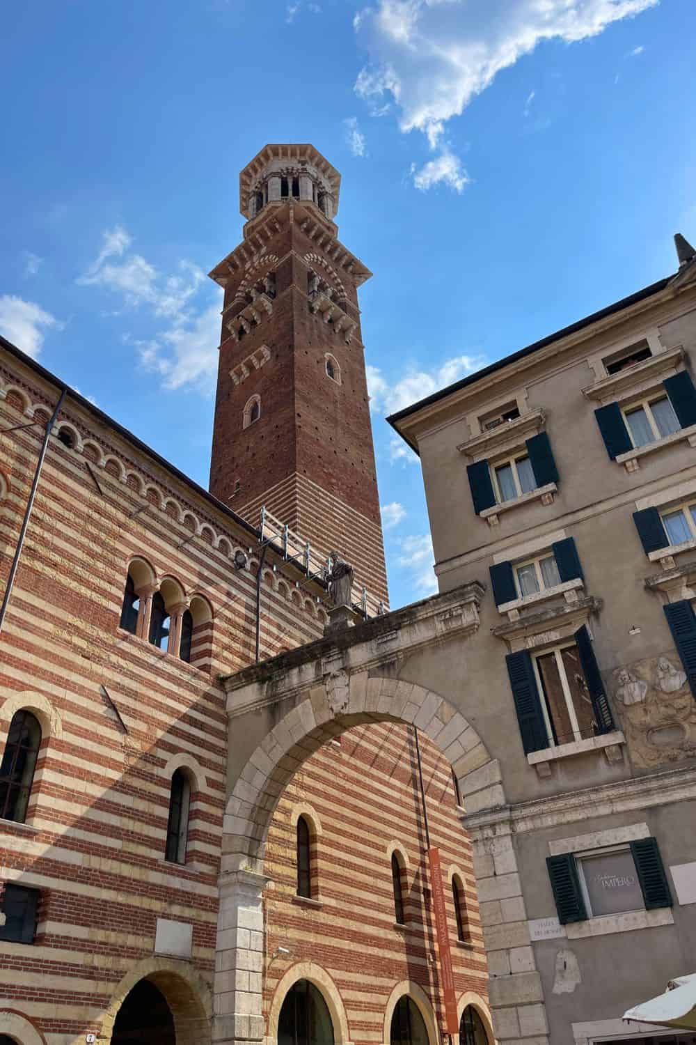 A picture of Torre Dei Lamberti tower taken from the bottom looking up. 