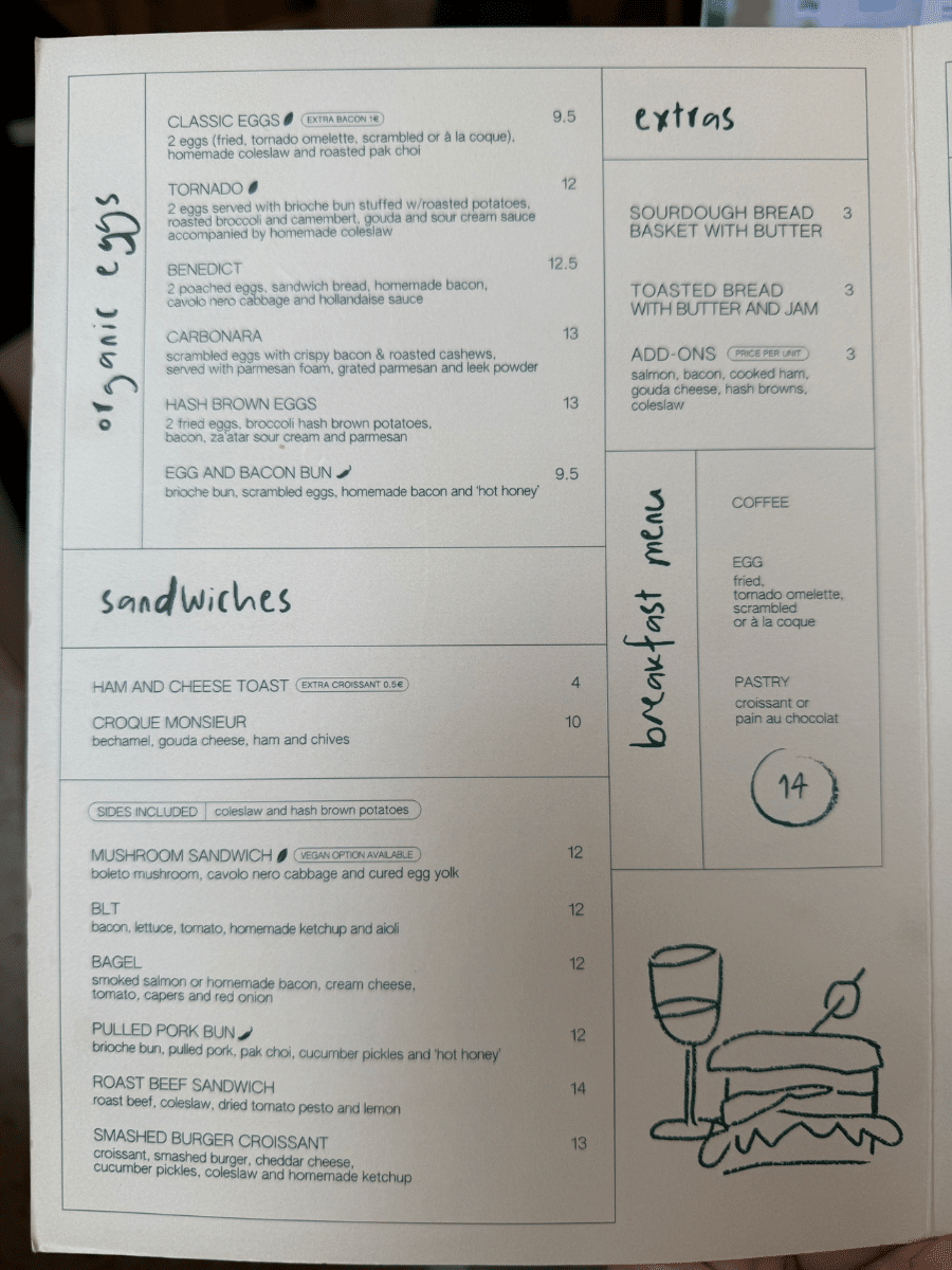 Breakfast menu from 'Do Beco' cafe, featuring organic egg dishes, sandwiches, and extras such as sourdough bread and pastries. The menu includes options like Tornado eggs, Carbonara, and Croque Monsieur, with detailed descriptions and prices.
