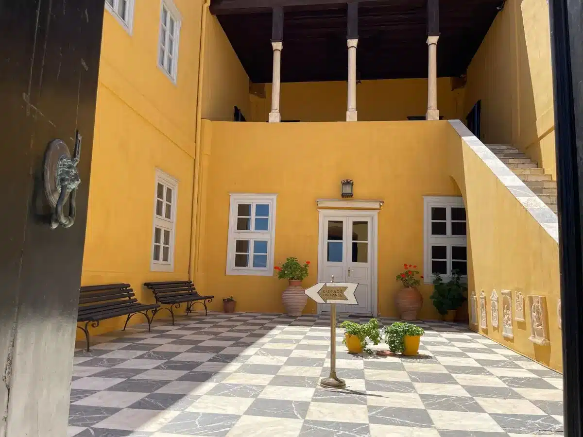 A yellow building that serves as the musuem in Hydra greece