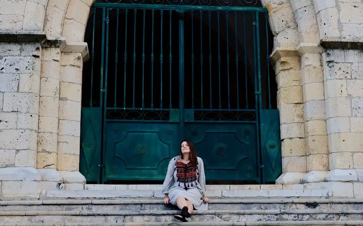 A solo woman traveling sitting at Igreja de Santa Maria