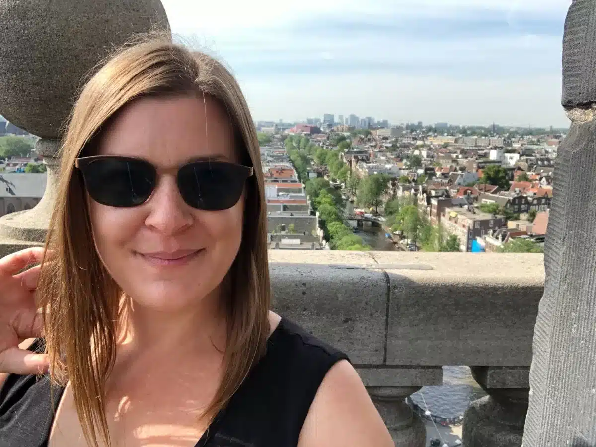 A woman in Amsterdam with the city in the background. 